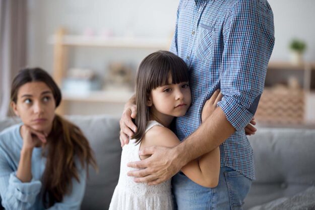 young girl hugging parent